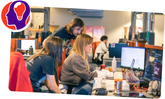 People looking over a computer screen