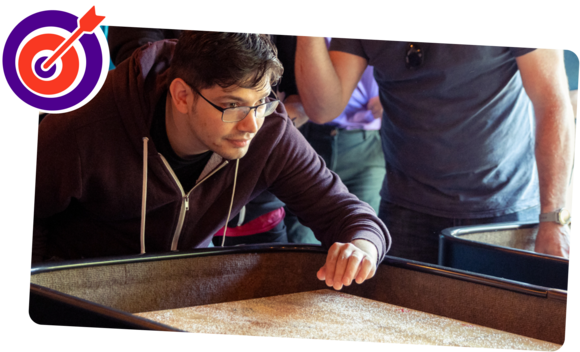 A focussed man just about to roll something on a table